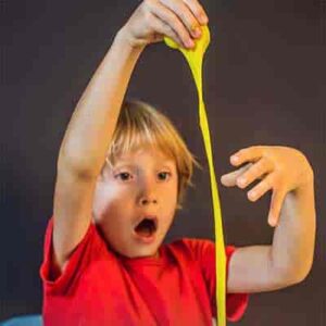Child is playing with yellow slime 